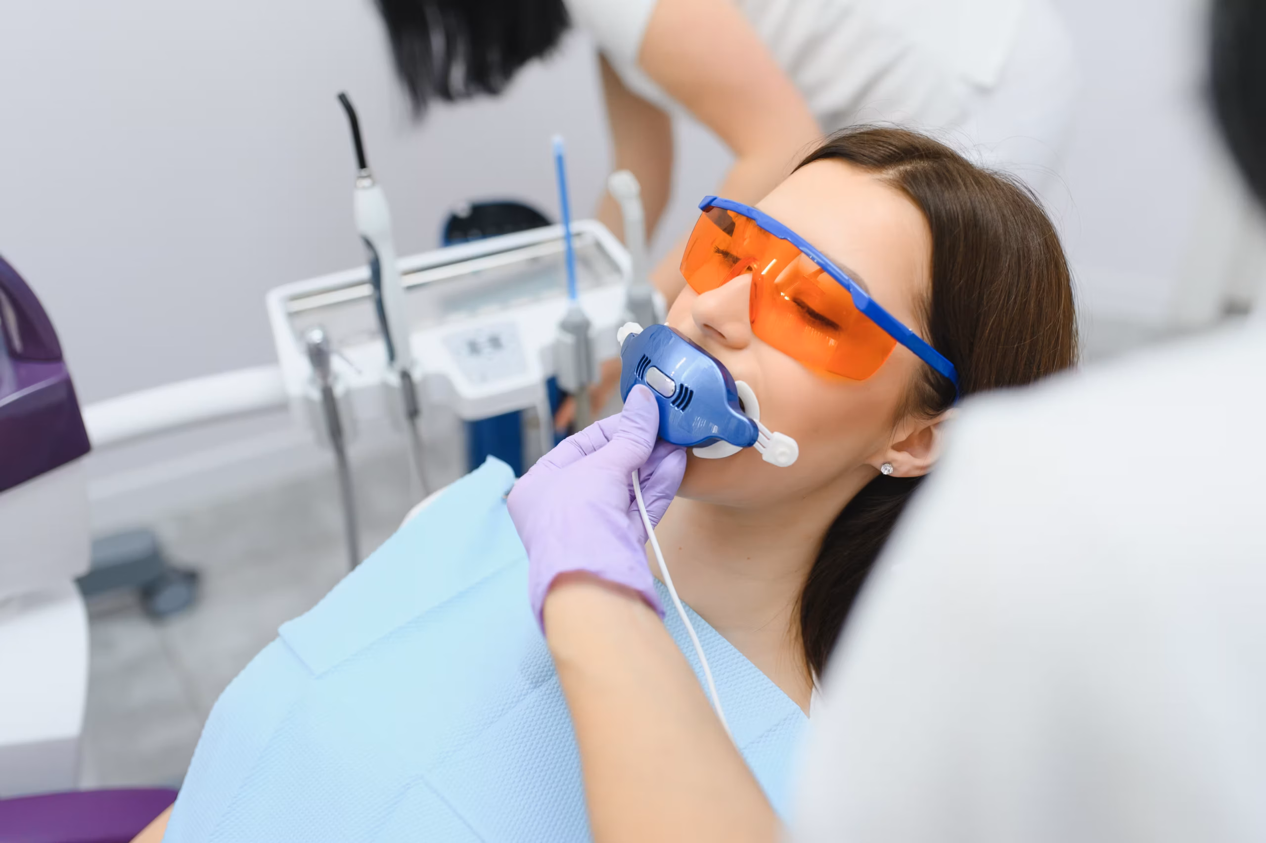 patient receiving nitrous oxide sedation wearing nasal mask and protective glasses during dental treatment
