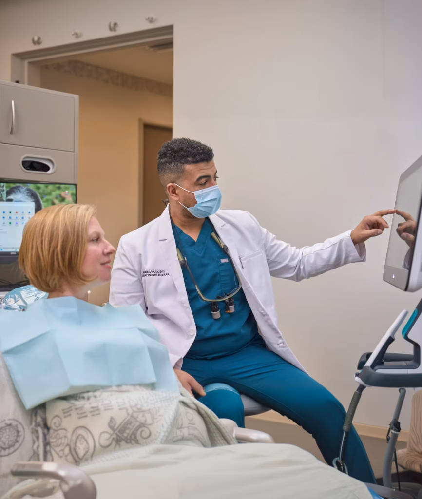 preventive dental consultation in San Antonio with dentist explaining oral health using digital screen