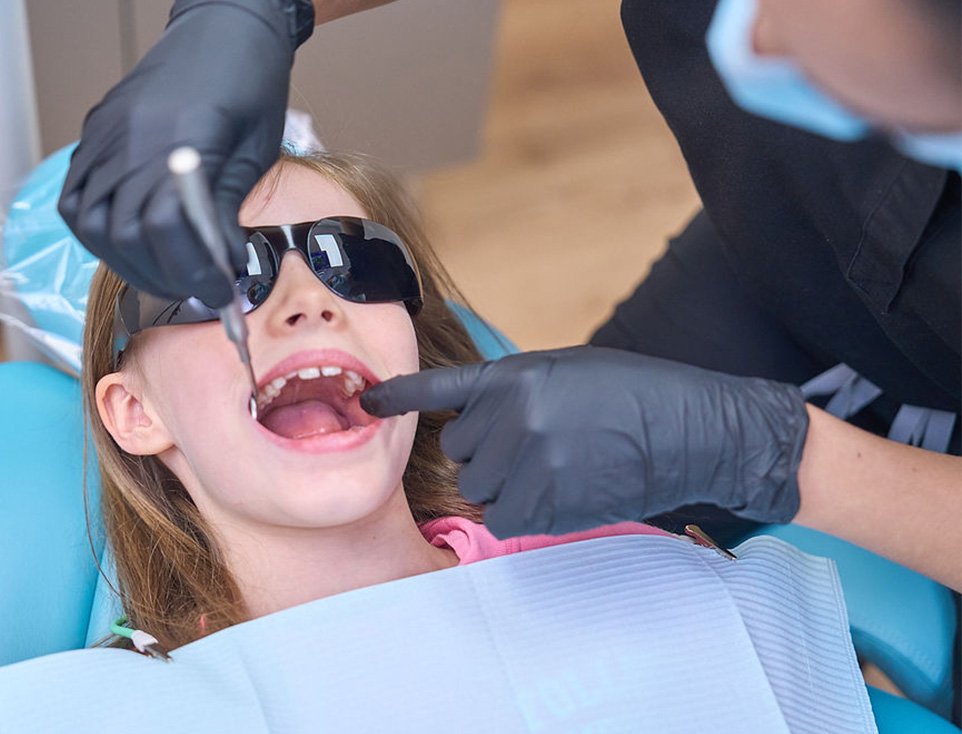 Young patient receiving a gentle dental procedure, highlighting expert root canal treatment services available in San Antonio.