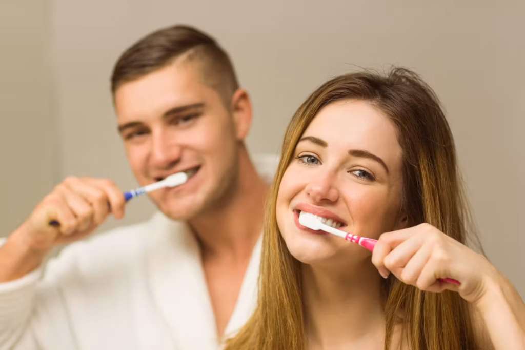 dental implant aftercare daily oral hygiene brushing teeth couple