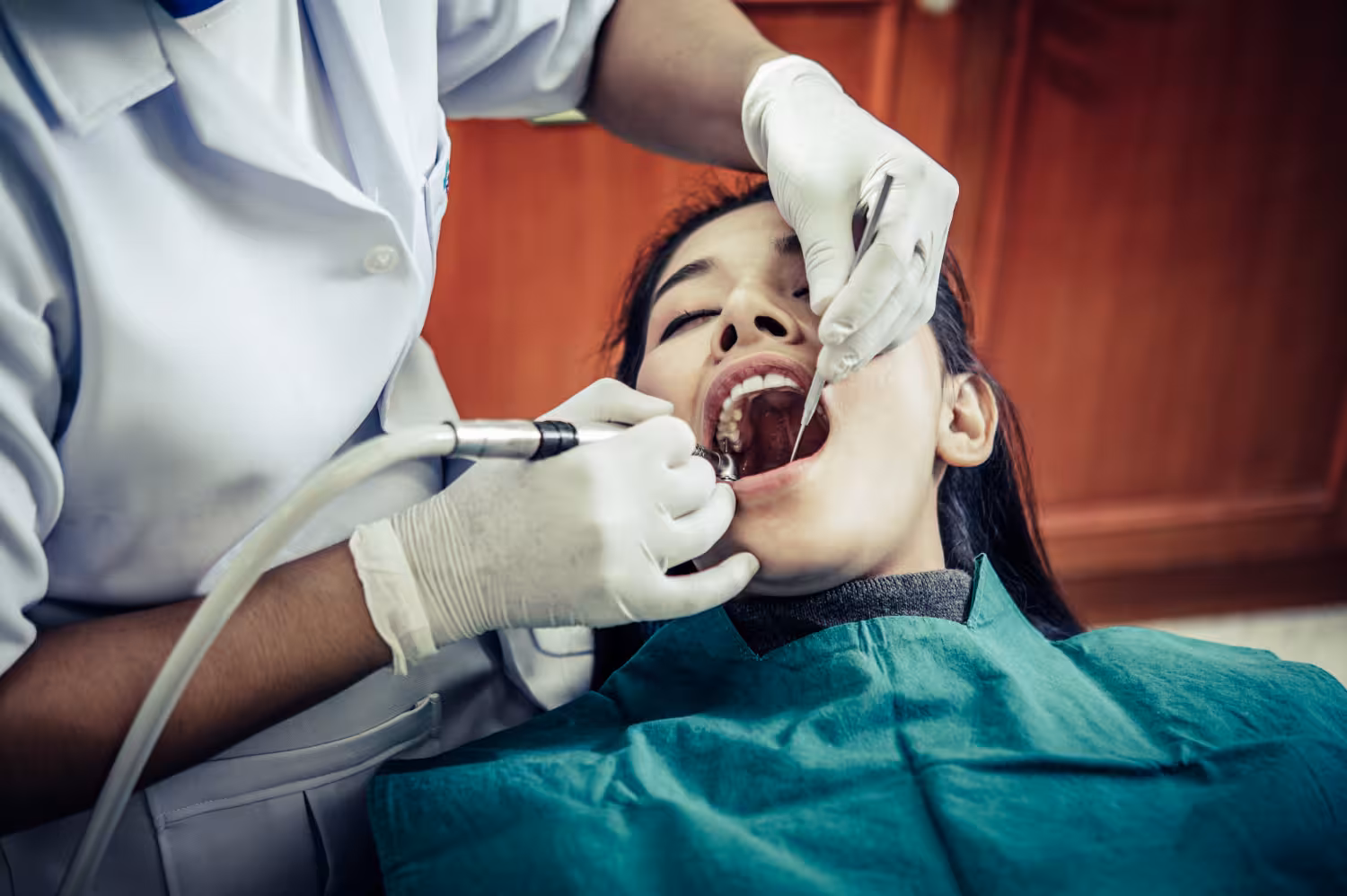 endodontic services in San Antonio with dentist performing root canal treatment to save infected tooth