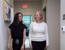 friendly dental staff in San Antonio guiding patient through clinic for comfortable dental experience