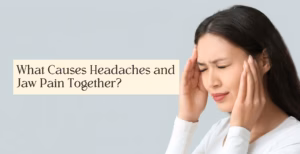 Person pressing hands to head and jaw, showing headache and jaw pain against plain background.