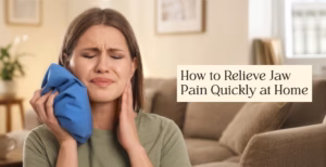 Person using ice pack on jaw for quick pain relief at home.