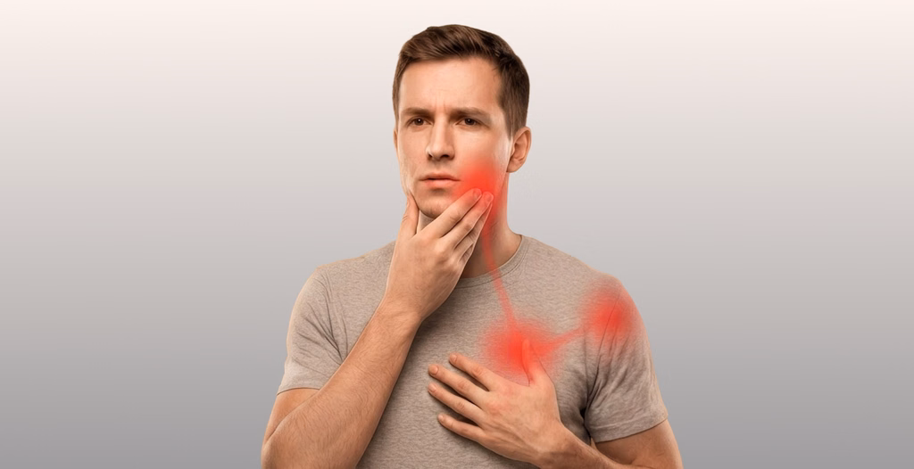 Man touching jaw and chest showing red pain highlights, set against a warm, softly blurred home interior background.